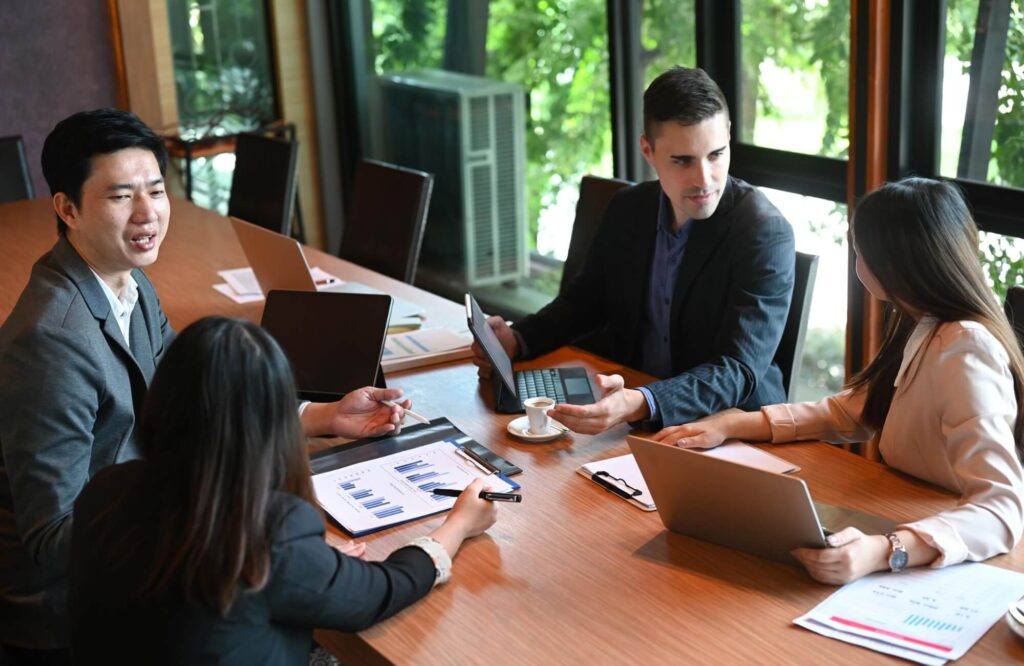 group of diverse business people at boardroom tabl 32lreb8